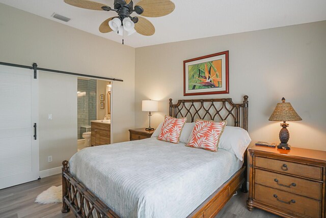 spacious closet with attic access and wood finished floors