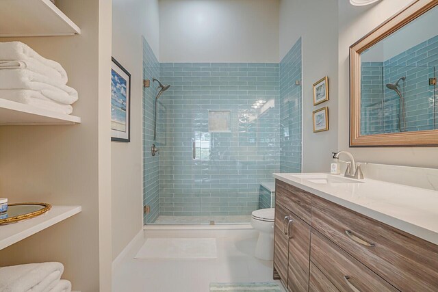 bathroom featuring walk in shower, tile patterned floors, vanity, and toilet