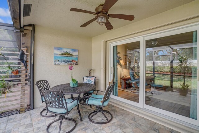 sunroom with ceiling fan