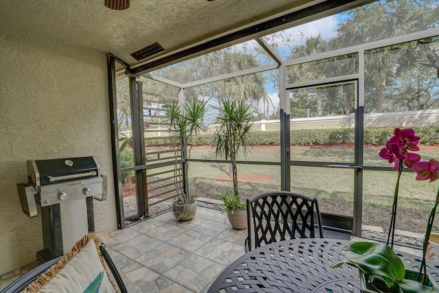 sunroom / solarium with a ceiling fan