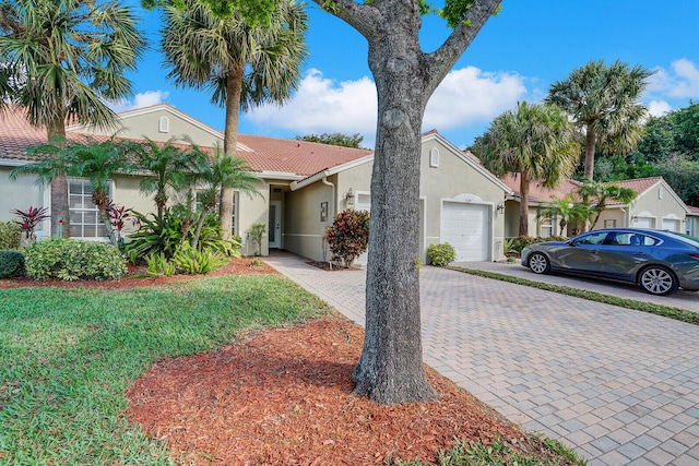 view of front of property featuring a garage and a front yard