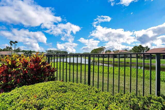 exterior space with a water view and a lawn