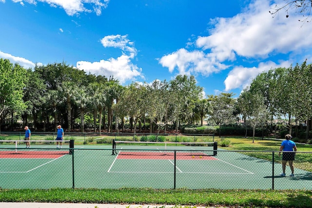 view of tennis court featuring fence