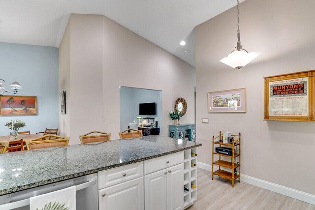 sitting room with a textured ceiling, light wood finished floors, and baseboards