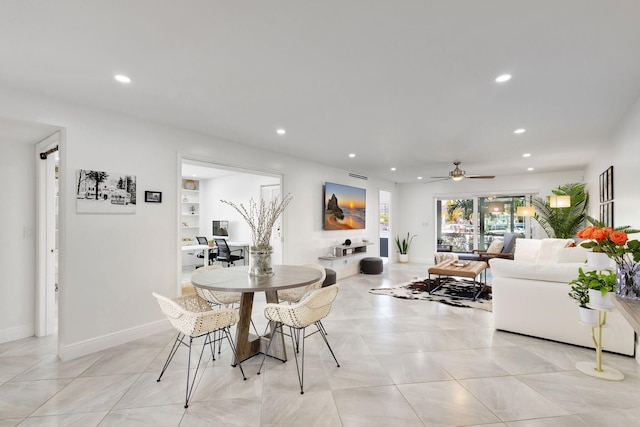 tiled dining space featuring ceiling fan