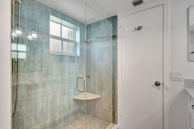 bathroom featuring an enclosed shower and vanity