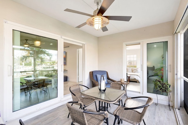 sunroom / solarium featuring ceiling fan