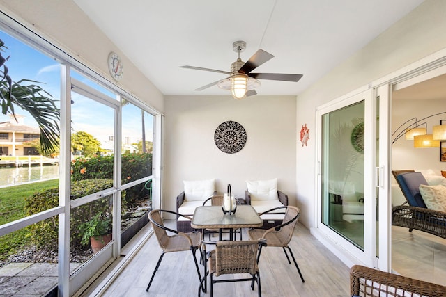 sunroom featuring ceiling fan