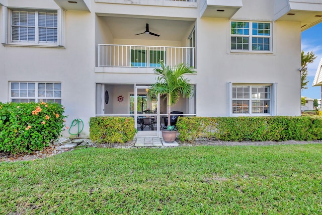 view of front of property featuring ceiling fan and a front yard