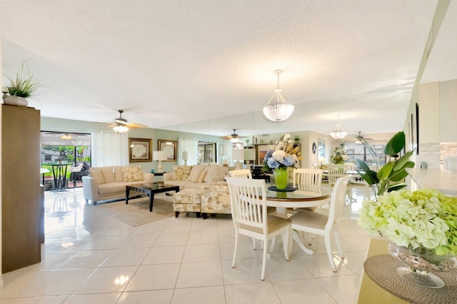 dining room featuring ceiling fan, light tile patterned flooring, and a wealth of natural light
