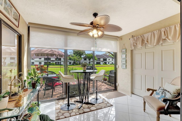 sunroom / solarium with plenty of natural light and a residential view