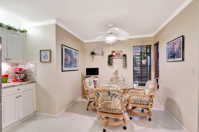 dining space with crown molding, a ceiling fan, and baseboards