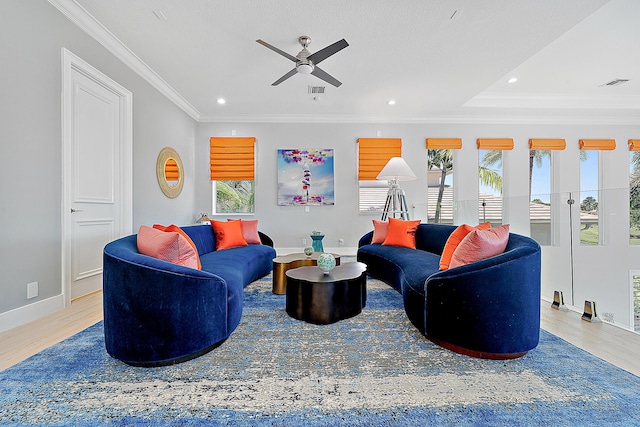 living room with hardwood / wood-style flooring, ornamental molding, plenty of natural light, and ceiling fan