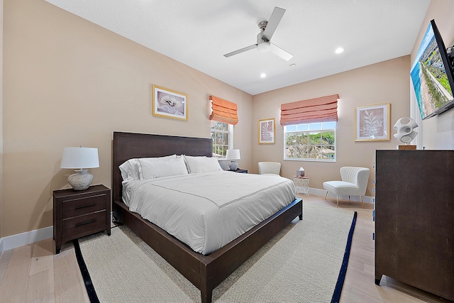 bedroom with ceiling fan and light hardwood / wood-style floors