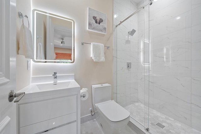 bathroom featuring vanity, toilet, and a shower with door