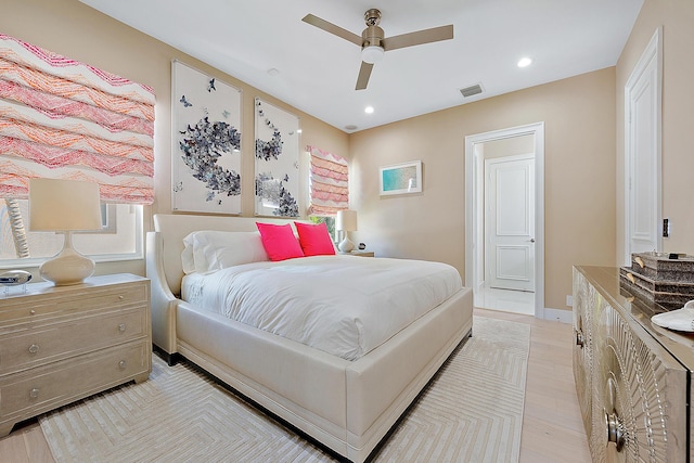 bedroom with light hardwood / wood-style floors and ceiling fan