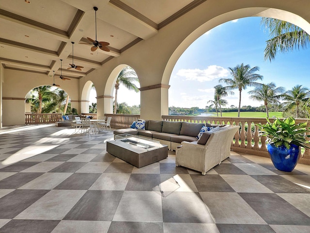 view of patio / terrace featuring an outdoor living space with a fire pit and ceiling fan