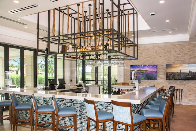 interior space with ornamental molding and bar area