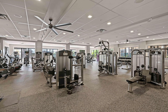 exercise room featuring a drop ceiling and ceiling fan