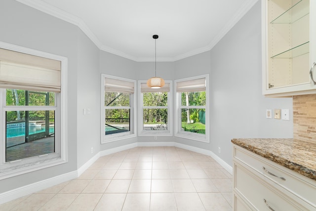 unfurnished dining area featuring light tile patterned flooring, a healthy amount of sunlight, and ornamental molding