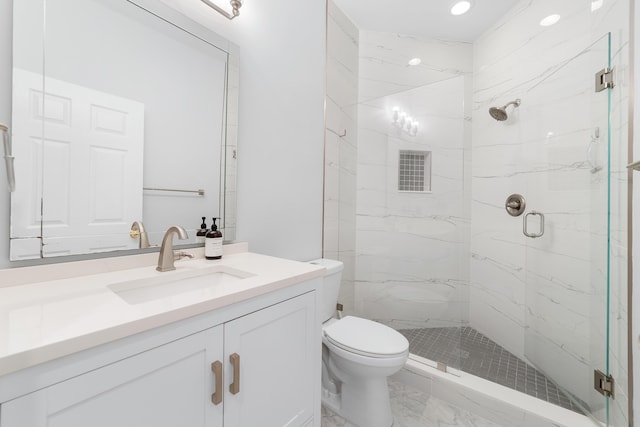 bathroom with toilet, vanity, and walk in shower