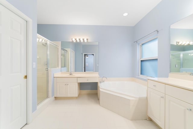 bathroom with tile patterned floors, vanity, and independent shower and bath