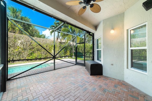 unfurnished sunroom with plenty of natural light and ceiling fan