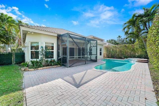 view of swimming pool featuring a patio and glass enclosure