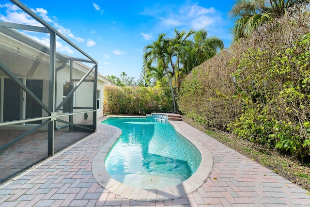 view of pool featuring a lanai and a patio area