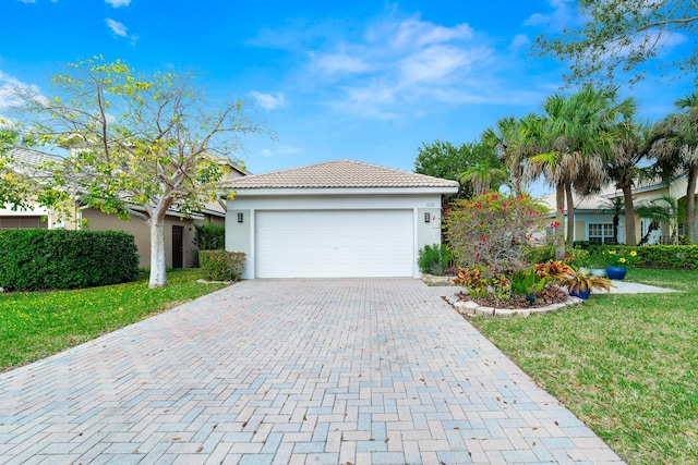 view of front of property featuring a garage and a front lawn