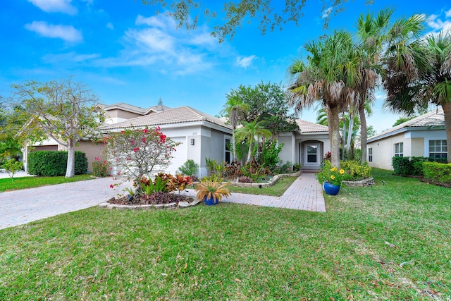 view of front of house featuring a garage and a front lawn