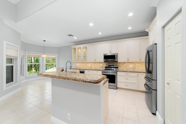 kitchen with light tile patterned flooring, sink, light stone counters, a center island with sink, and appliances with stainless steel finishes