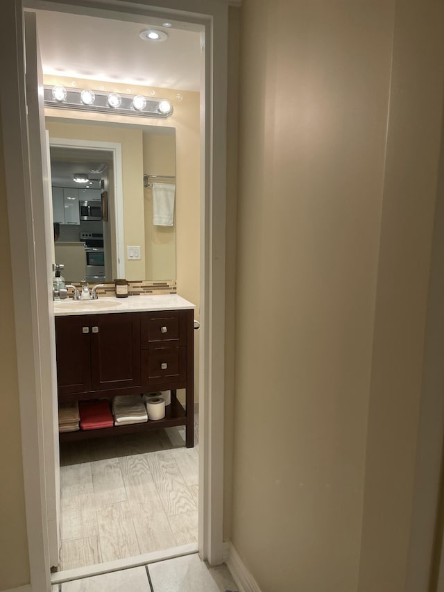 bathroom with hardwood / wood-style flooring and vanity