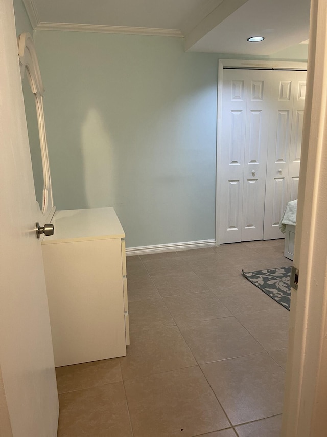 hallway featuring tile patterned flooring and ornamental molding