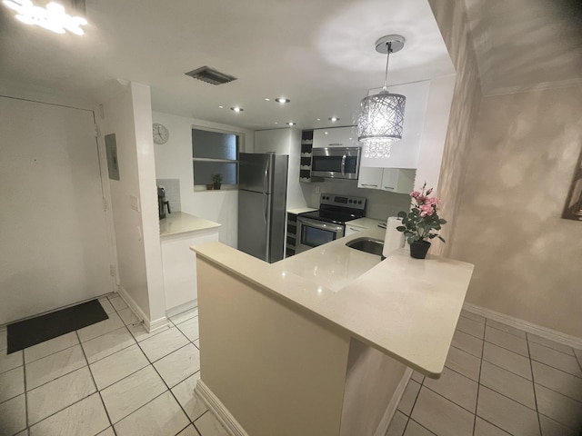 kitchen with pendant lighting, white cabinets, light tile patterned floors, kitchen peninsula, and stainless steel appliances