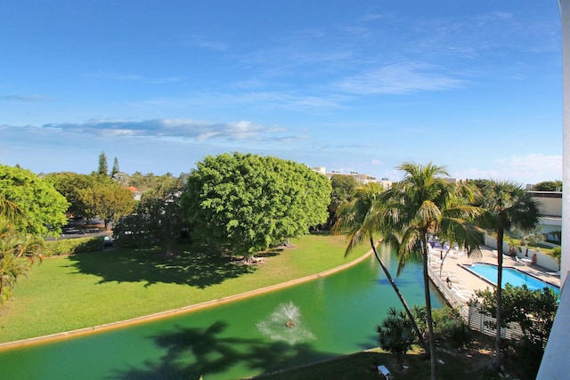 surrounding community with a water view, a swimming pool, and a lawn