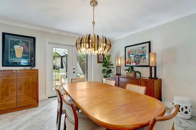 dining space with light wood-style flooring, baseboards, a chandelier, and crown molding