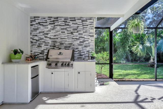 exterior space with a wealth of natural light, light countertops, and white cabinetry