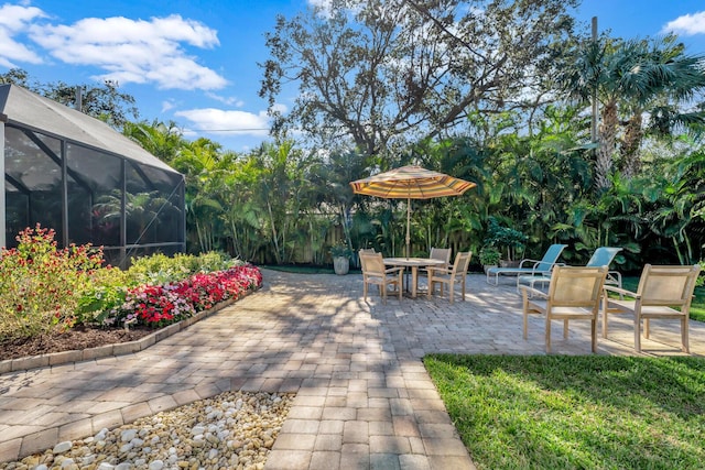 view of patio / terrace featuring glass enclosure