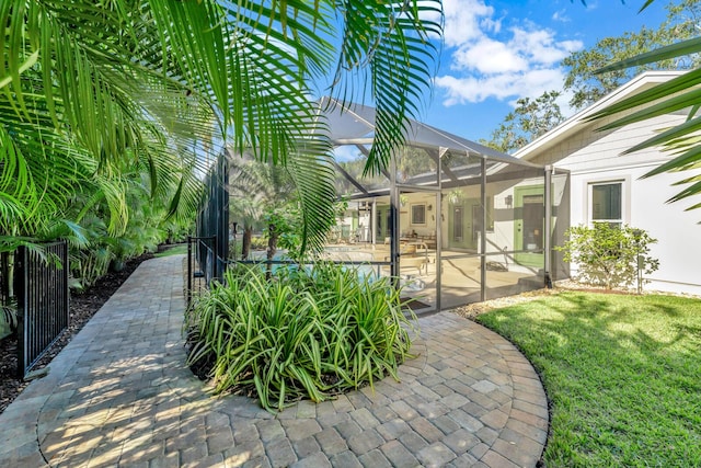 exterior space with glass enclosure and a patio