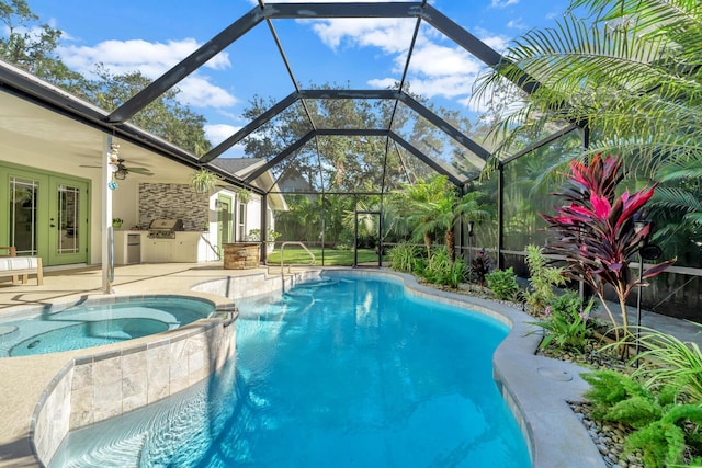 view of swimming pool with exterior kitchen, a pool with connected hot tub, a patio area, and french doors