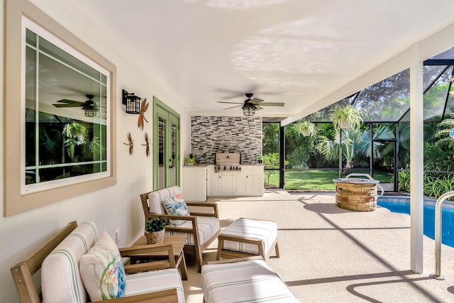 view of patio / terrace with an outdoor hangout area, glass enclosure, ceiling fan, exterior kitchen, and an outdoor pool