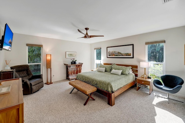 bedroom featuring light carpet, ceiling fan, visible vents, and baseboards