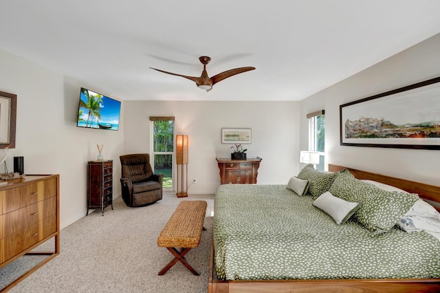 carpeted bedroom featuring ceiling fan and baseboards