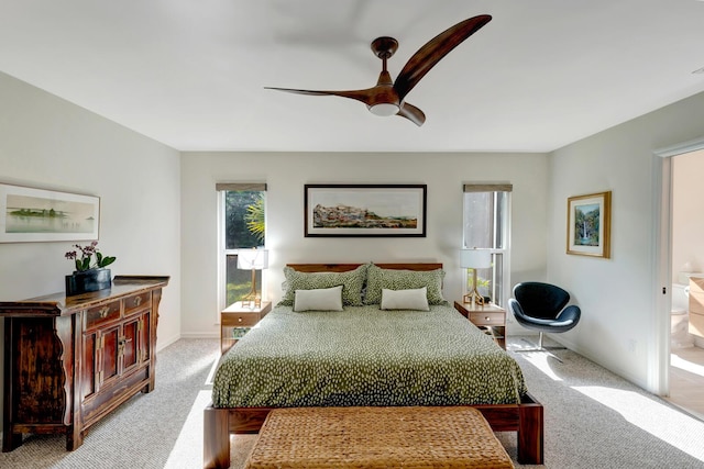 bedroom featuring a ceiling fan, light carpet, and baseboards