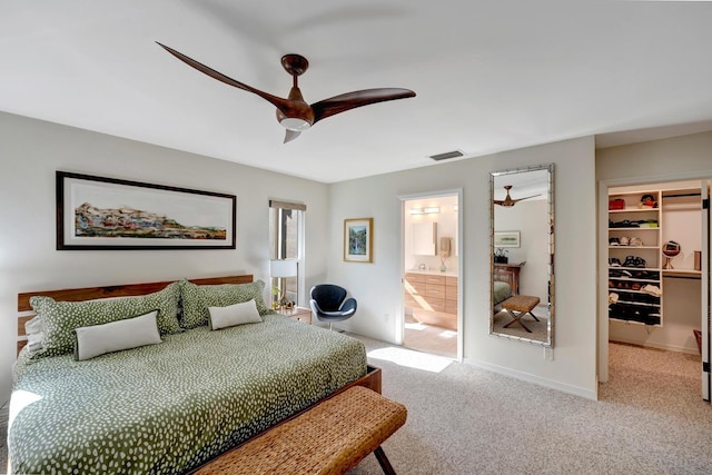 bedroom featuring visible vents, connected bathroom, ceiling fan, a spacious closet, and carpet floors