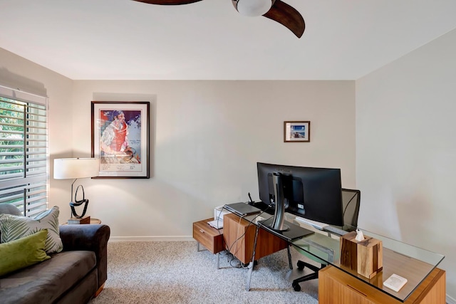 office area with baseboards, a ceiling fan, and light colored carpet