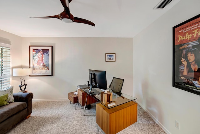 home office with baseboards, visible vents, a ceiling fan, and light colored carpet