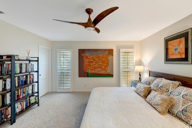 bedroom featuring visible vents, baseboards, a ceiling fan, and light colored carpet