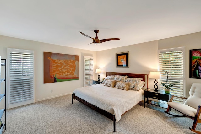 bedroom featuring light carpet, a ceiling fan, and baseboards